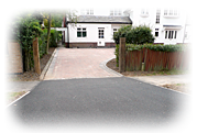 an image of an impressive tarmac and brick pattern house driveway